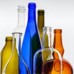 a group of glass bottles sitting next to each other